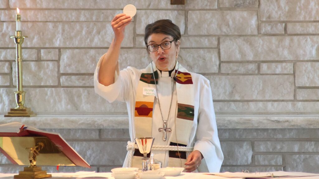 Pastor blessing communion wafer