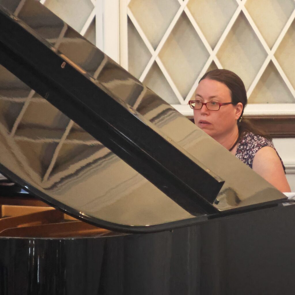 Pianist playing a grand piano