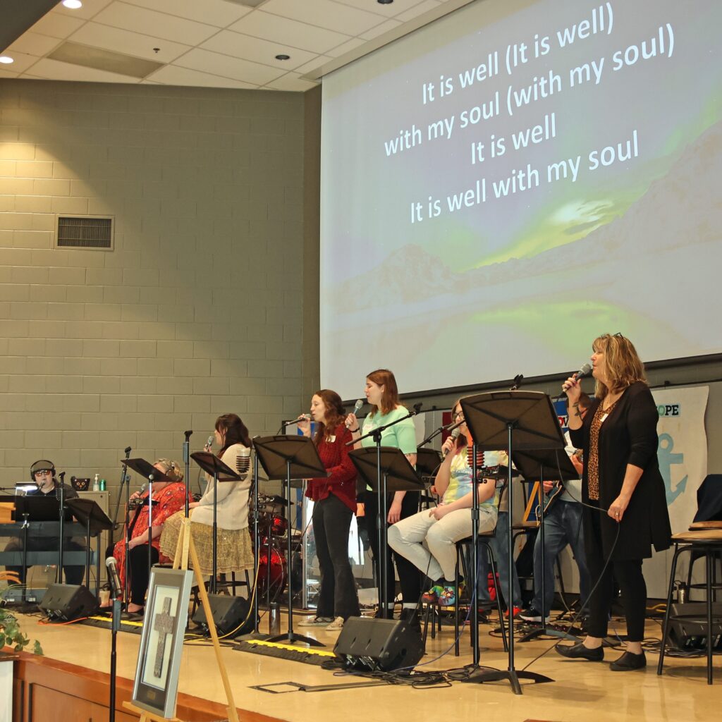 Group of musicians performing on a stage during a worship service