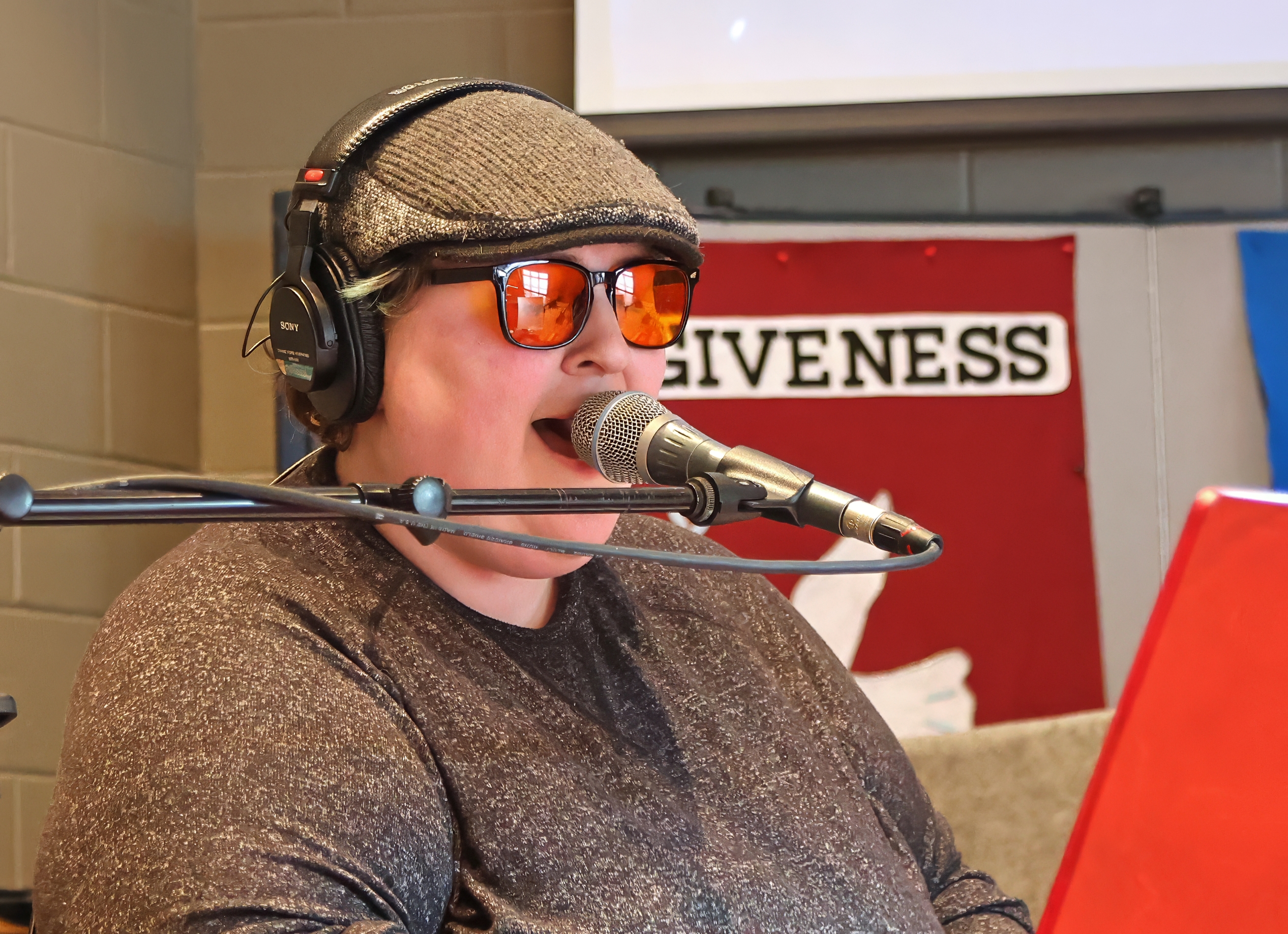 Person singing into a microphone