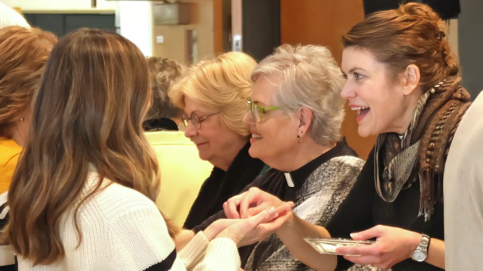 Pastor offering communion to churchgoer