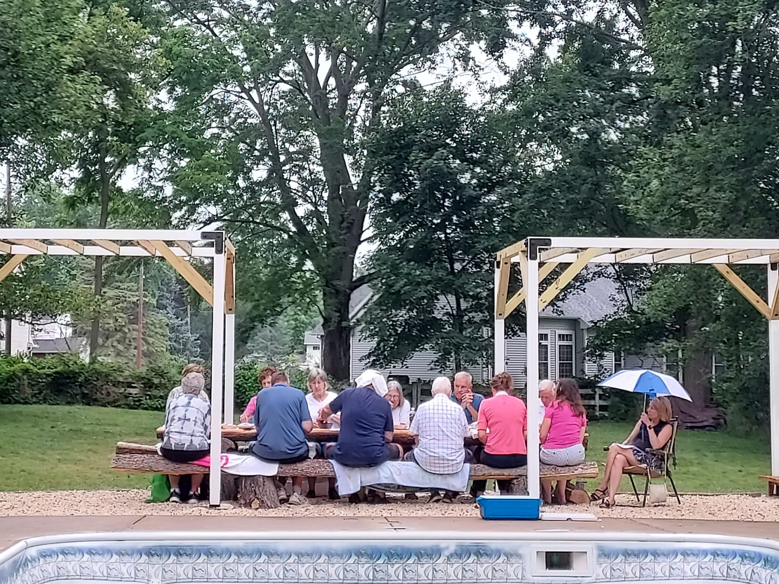 Group sitting outdoors at a picnic table