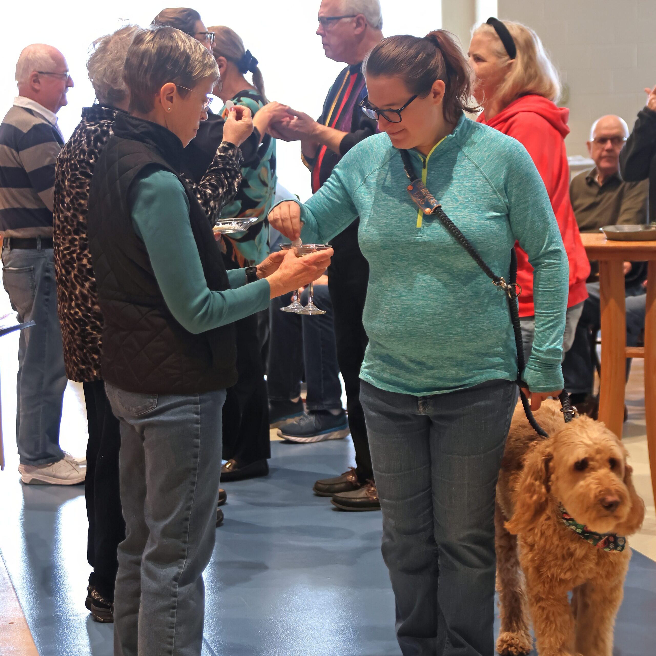 A person with a service dog takes communion at church