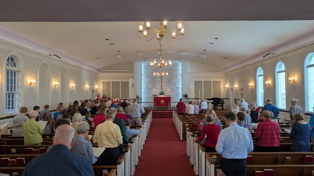 A church sanctuary with filled with people during a worship service