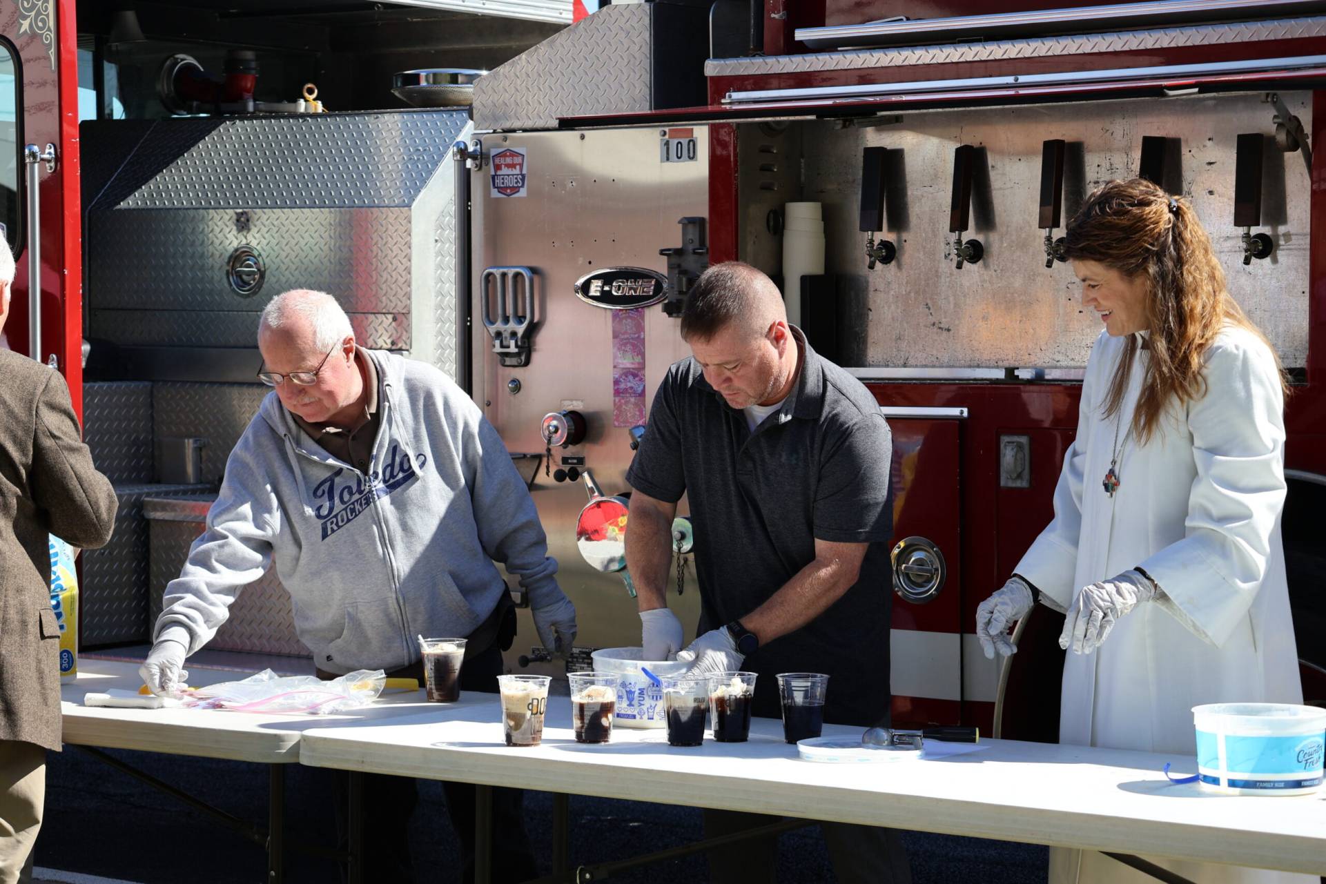 Volunteers serve root beer floats during an outdoor church event