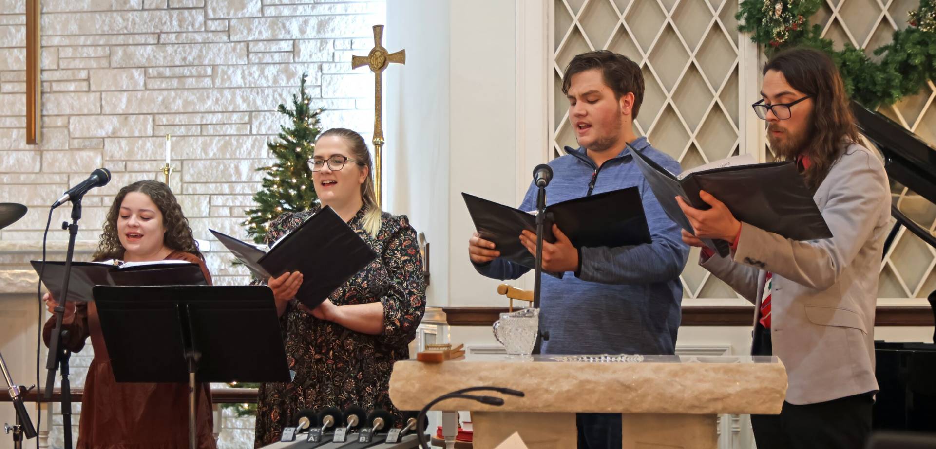 Four vocalists sing during a church service